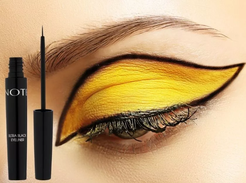 Note ultra black eyeliner model with yellow eyeshadow and graphic liner