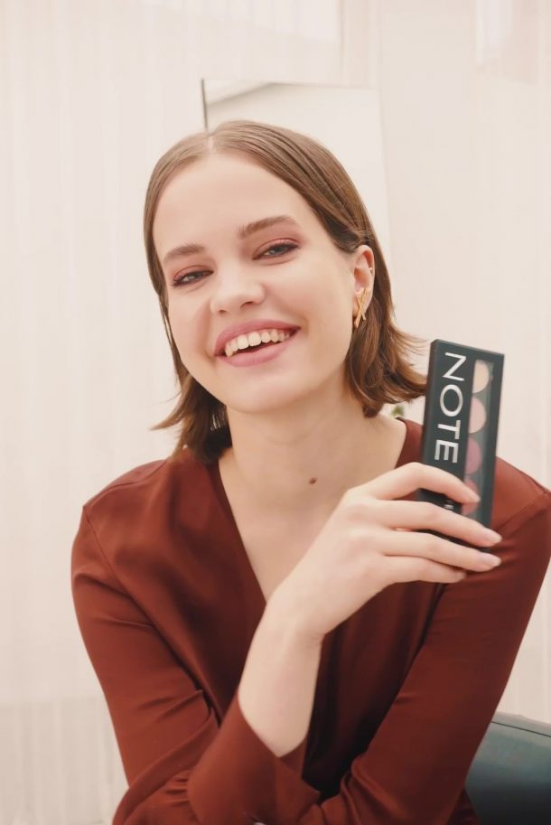 Note model photoshoot warmed toned eye holding professional eyeshadow 107