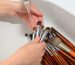 hands of make-up artist washed cosmetic brushes with clean water
